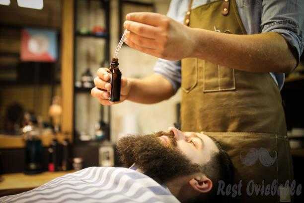 Barber putting beard oil to client What Is Beard Oil And The Ingredients Involved Within Beard Oil?